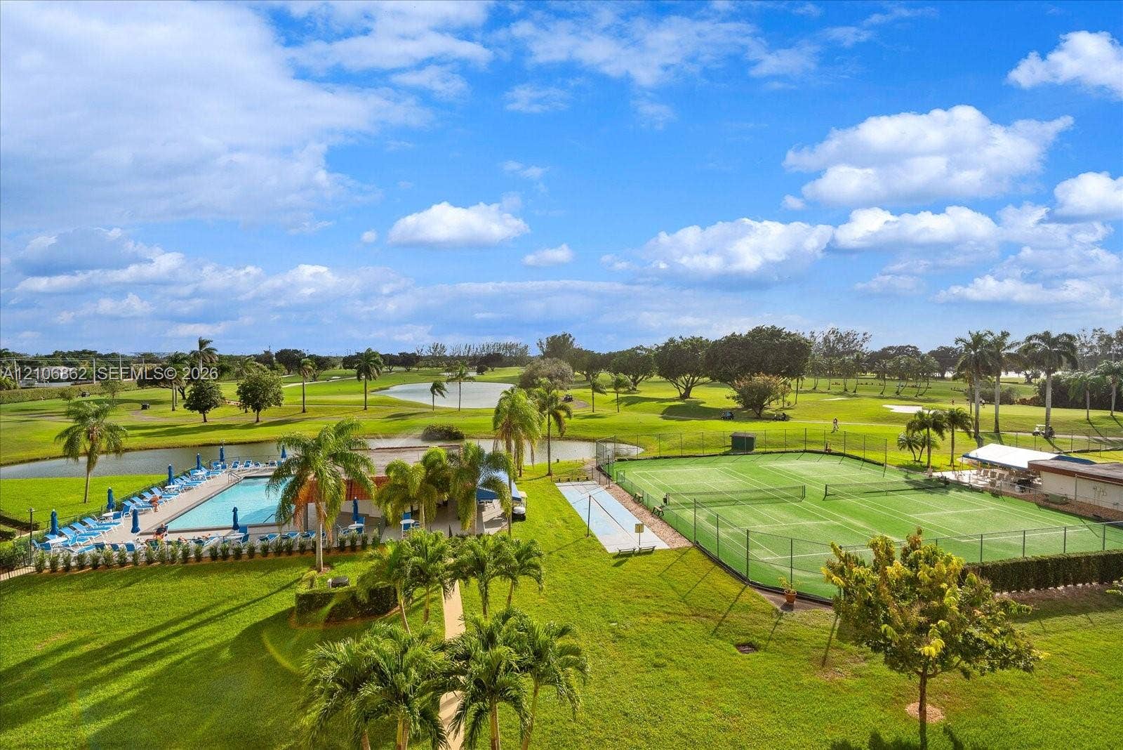 Outdoor amenities include a swimming pool, two tennis courts, landscaped grounds, and a water feature