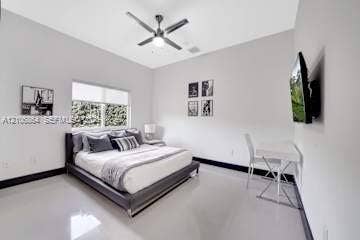 885 SW 144th Avenue, Miami, FL 33184 Neutral-toned interior featuring high ceilings, a ceiling fan with integrated lighting, polished flooring, and a large window
