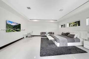 885 SW 144th Avenue, Miami, FL 33184 Spacious room featuring high ceilings with recessed tray lighting, polished tile flooring, and horizontal picture windows