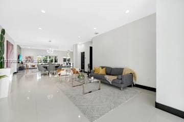 885 SW 144th Avenue, Miami, FL 33184 Open-concept living space featuring high ceilings, recessed lighting, and polished stone flooring throughout