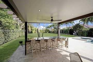 885 SW 144th Avenue, Miami, FL 33184 Covered patio featuring a built-in outdoor bar with stone veneer, recessed ceiling lighting, a ceiling fan, and stone-tile flooring