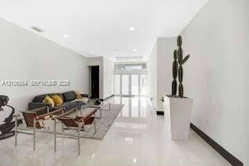 885 SW 144th Avenue, Miami, FL 33184 Open interior space featuring high ceilings, polished tile flooring, recessed lighting, and expansive glass-paned double doors