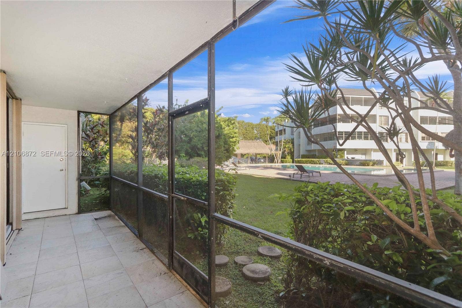 Screened lanai featuring tile flooring and metal frame enclosure