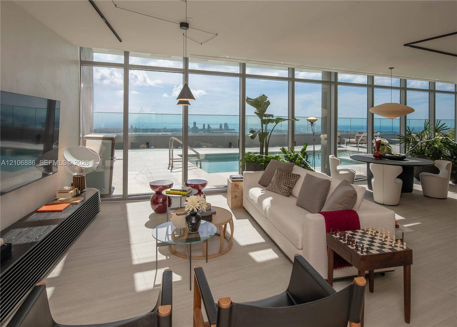1400 Biscayne Boulevard, #2603, Miami, FL 33132 Floor-to-ceiling glass walls, expansive terrace, private swimming pool, neutral stone-finish tile flooring, and integrated ceiling lighting