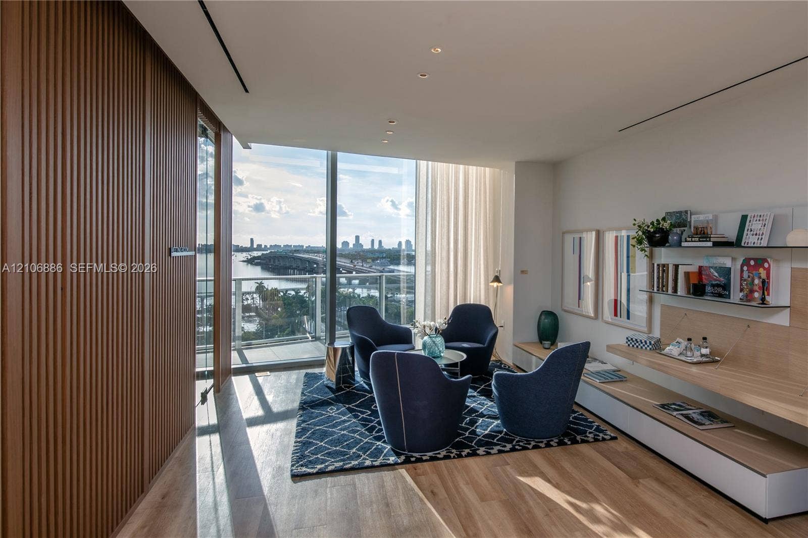 1400 Biscayne Boulevard, #2603, Miami, FL 33132 Floor-to-ceiling windows, integrated wood-slat wall paneling, built-in wall shelving with light wood finish, recessed ceiling lighting, and wood-finish flooring
