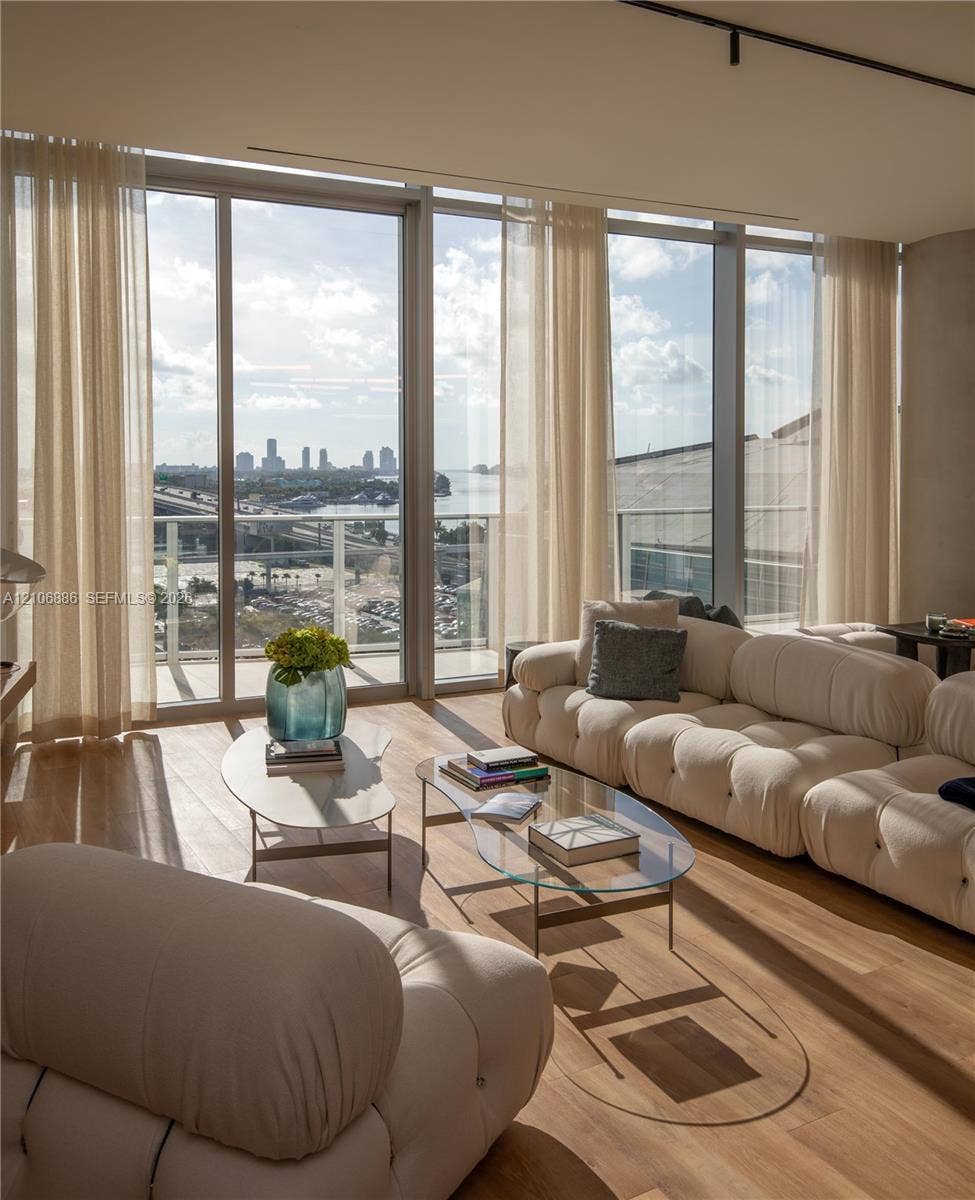 1400 Biscayne Boulevard, #2603, Miami, FL 33132 Floor-to-ceiling glass windows, wide-plank wood-finish flooring, and an expansive balcony featuring a glass railing