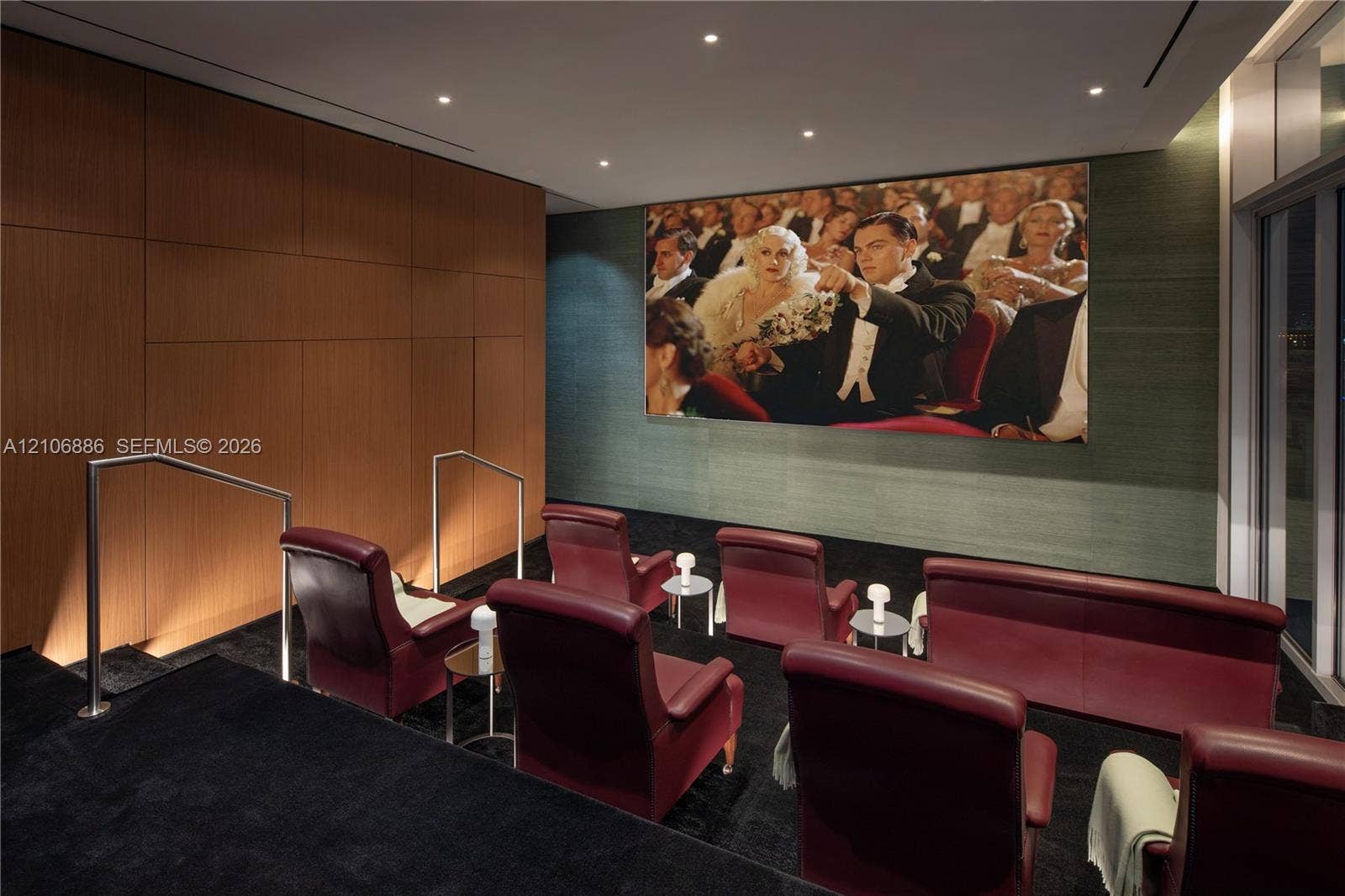 1400 Biscayne Boulevard, #2603, Miami, FL 33132 Media room featuring tiered flooring, wood-panel wall accents, recessed ceiling lighting, and integrated wall-mounted projection screen