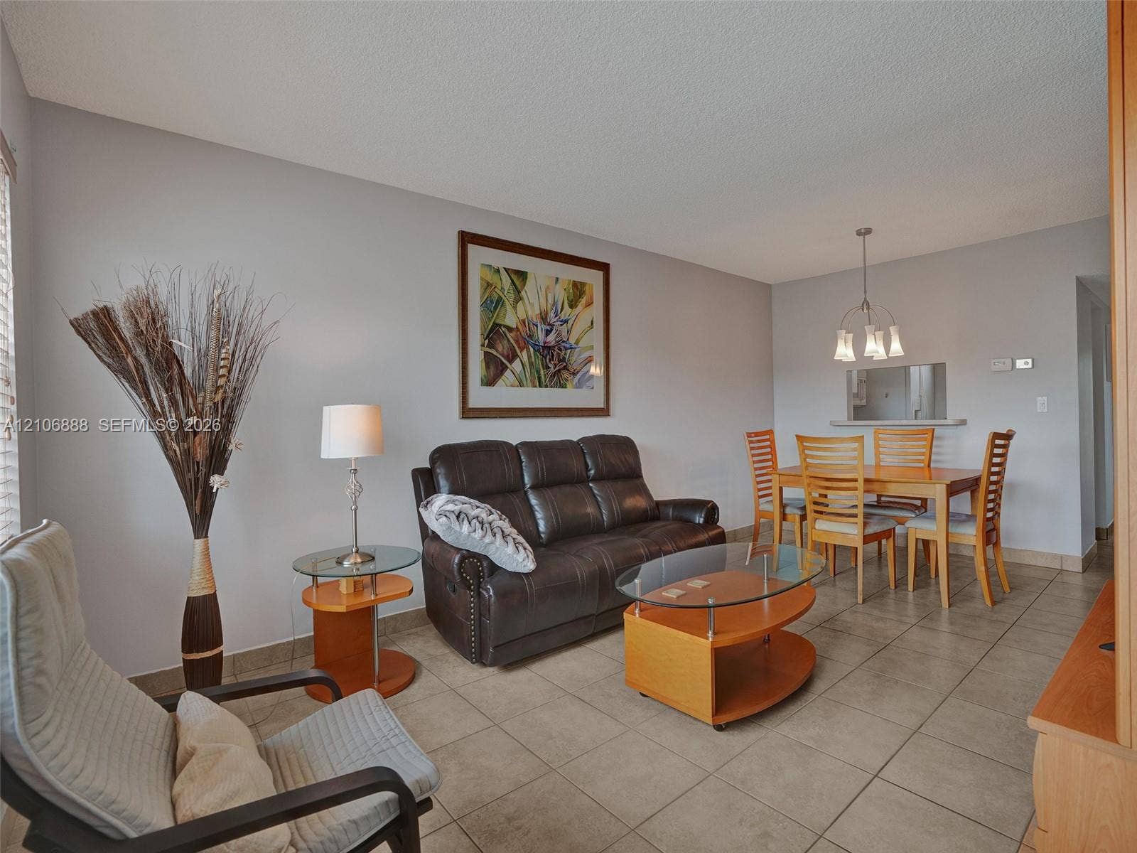3506 NW 49th Avenue, #508, Lauderdale Lakes, FL 33319 Open-concept area featuring neutral wall paint, ceramic tile flooring, and a multi-light chandelier fixture