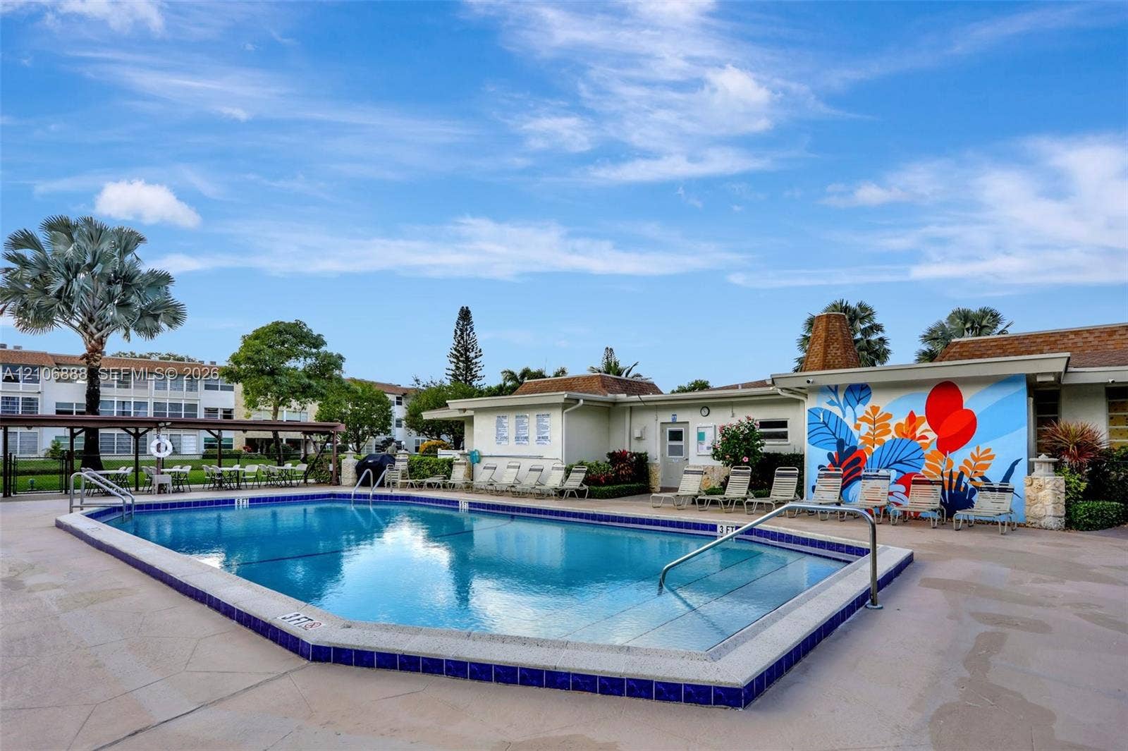 3506 NW 49th Avenue, #508, Lauderdale Lakes, FL 33319 In-ground swimming pool with tile trim, concrete deck, and built-in metal handrails