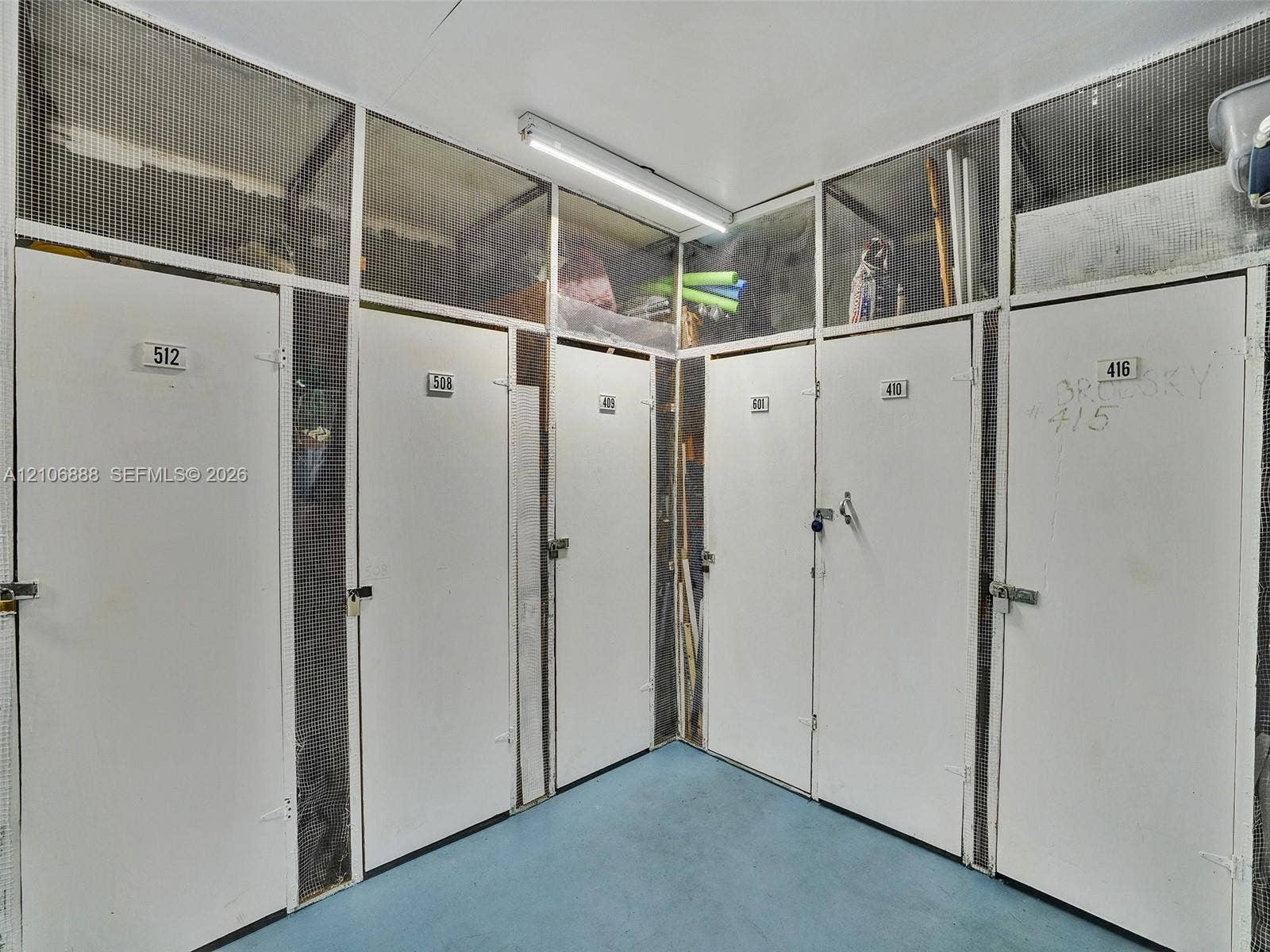 3506 NW 49th Avenue, #508, Lauderdale Lakes, FL 33319 Dedicated storage lockers featuring solid-panel doors with integrated metal mesh ventilation and surface-mounted overhead lighting