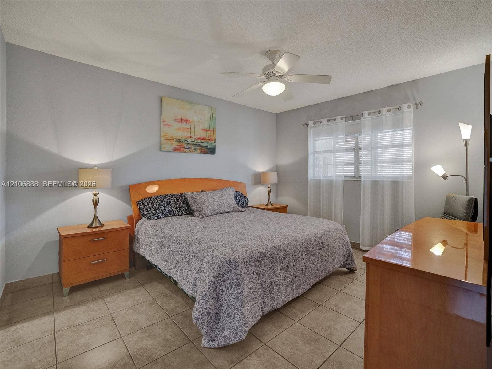 3506 NW 49th Avenue, #508, Lauderdale Lakes, FL 33319 Neutral-tone interior featuring large-format ceramic tile flooring, a ceiling fan with integrated light fixture, and horizontal window blinds