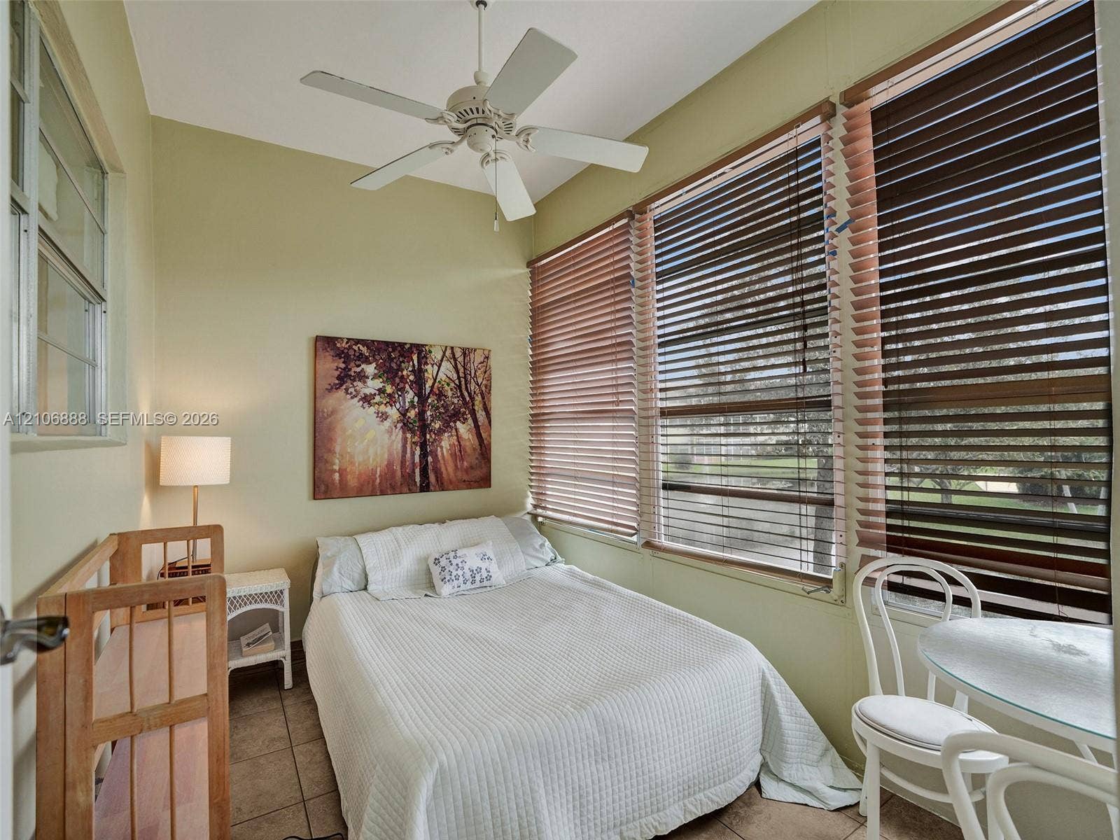 3506 NW 49th Avenue, #508, Lauderdale Lakes, FL 33319 Multi-pane window configuration, horizontal window blinds, and white ceiling fan with integrated lighting