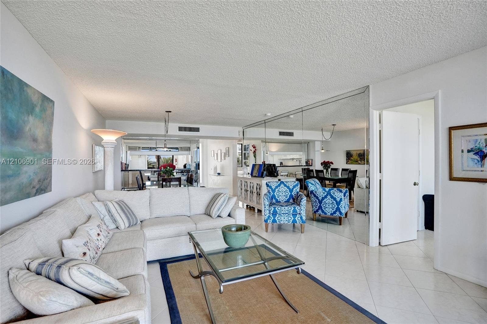 510 N Ocean Boulevard, #308, Pompano Beach, FL 33062 Open-concept interior featuring large-format diagonal tile flooring and floor-to-ceiling wall mirrors