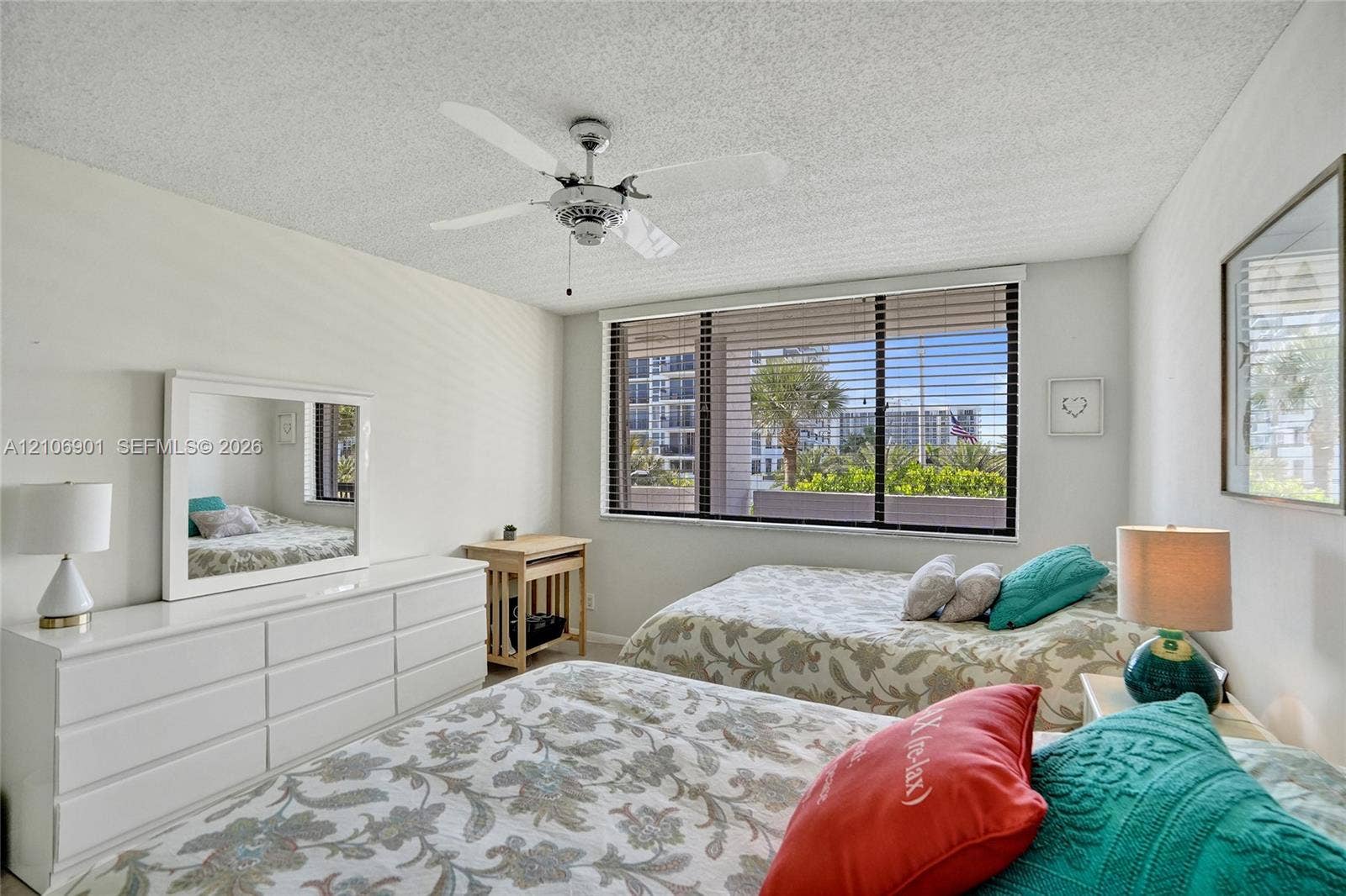 510 N Ocean Boulevard, #308, Pompano Beach, FL 33062 Neutral-toned room featuring a ceiling fan with integrated lighting and a large window with horizontal blinds