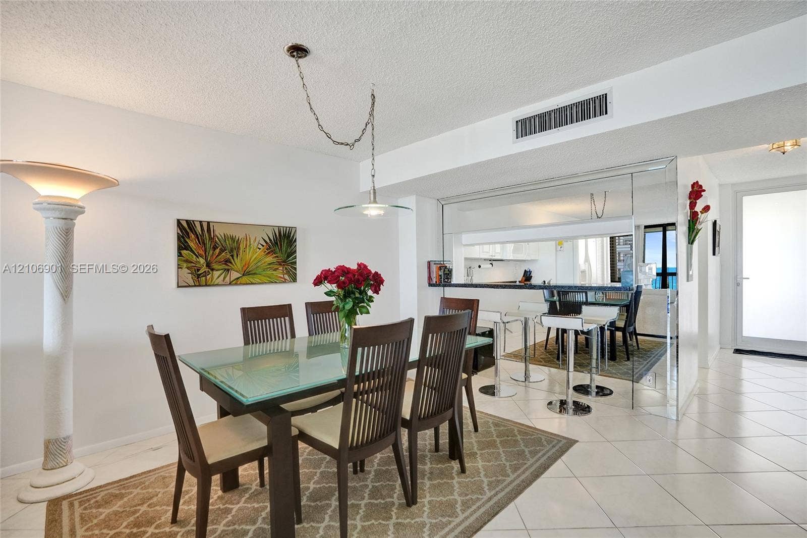 510 N Ocean Boulevard, #308, Pompano Beach, FL 33062 Ceramic tile flooring, mirrored wall accents, built-in breakfast bar, and pendant lighting