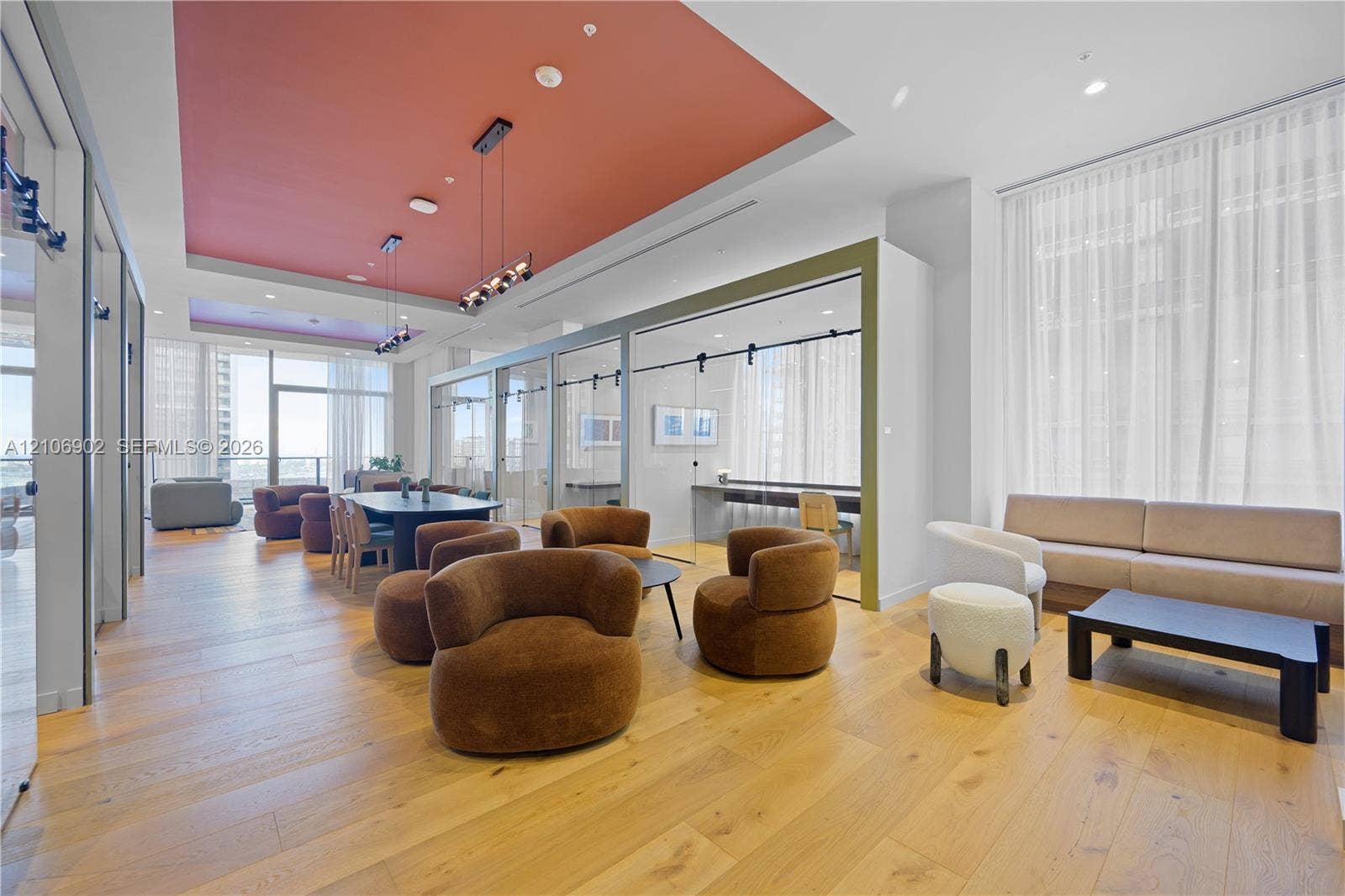 11 NE 6th Street, #1111, Miami, FL 33132 Open-concept interior featuring light wood-finish flooring, floor-to-ceiling windows, structural glass partitions, and a recessed ceiling with accent color detail