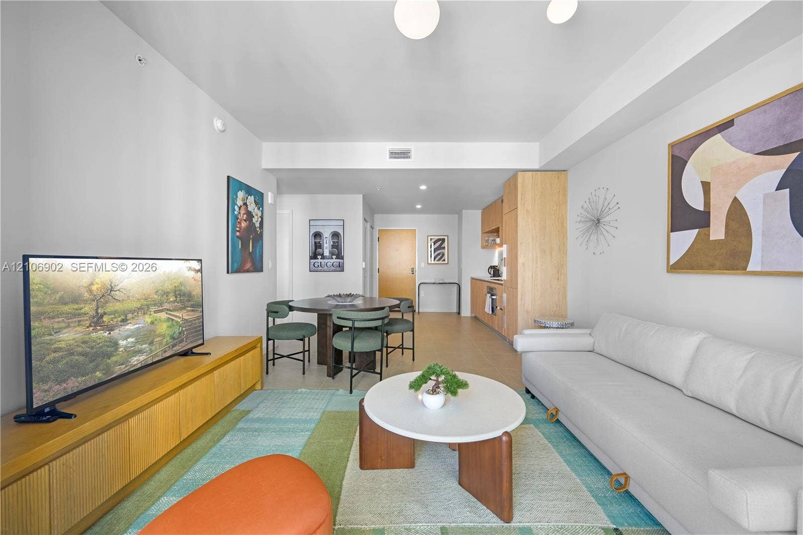 11 NE 6th Street, #1111, Miami, FL 33132 Open-concept living space featuring wood-finish flooring, light-toned cabinetry, and recessed lighting
