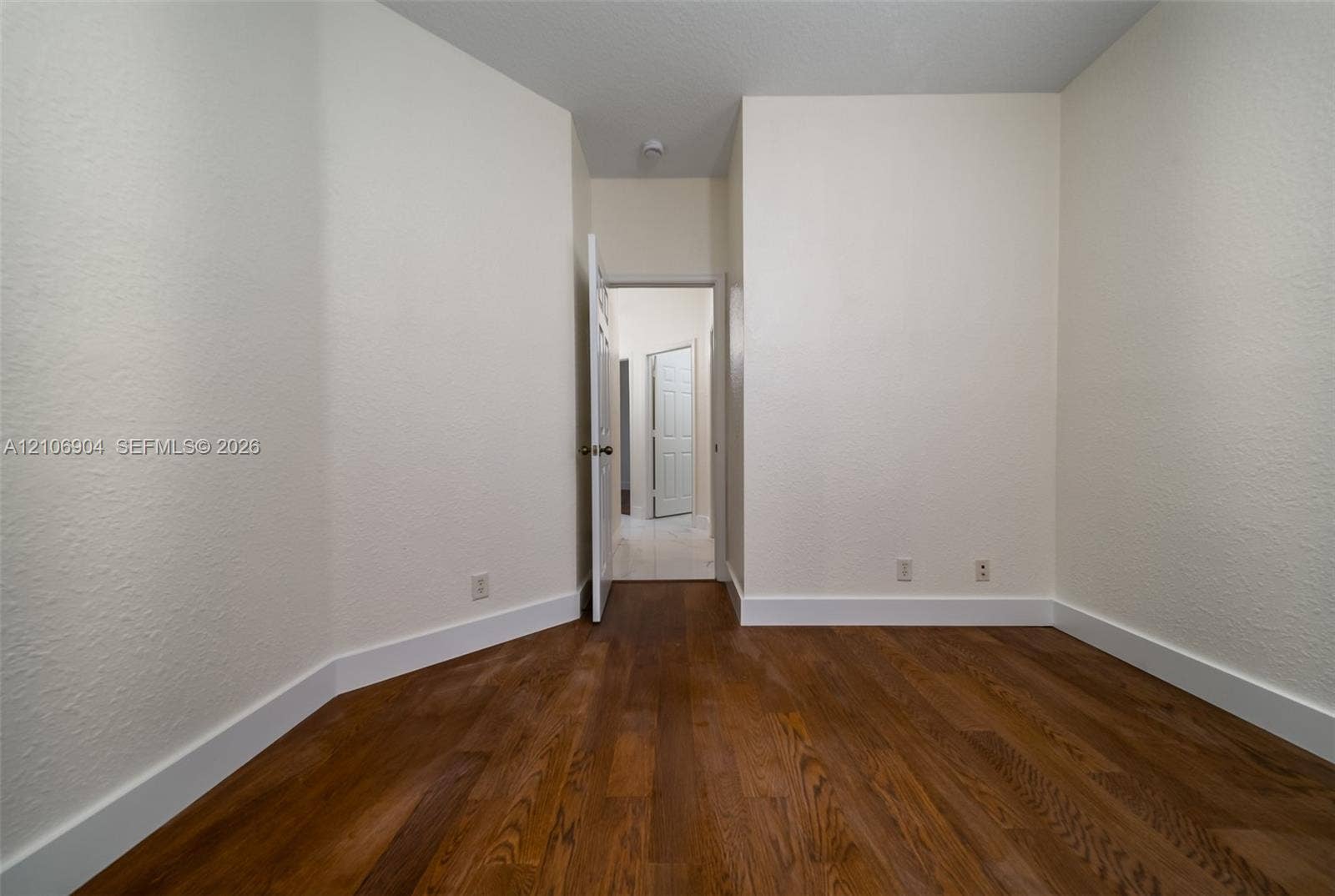 297 Conservation Drive, Weston, FL 33327 Room featuring wood-finish flooring, textured walls, and paneled interior doors
