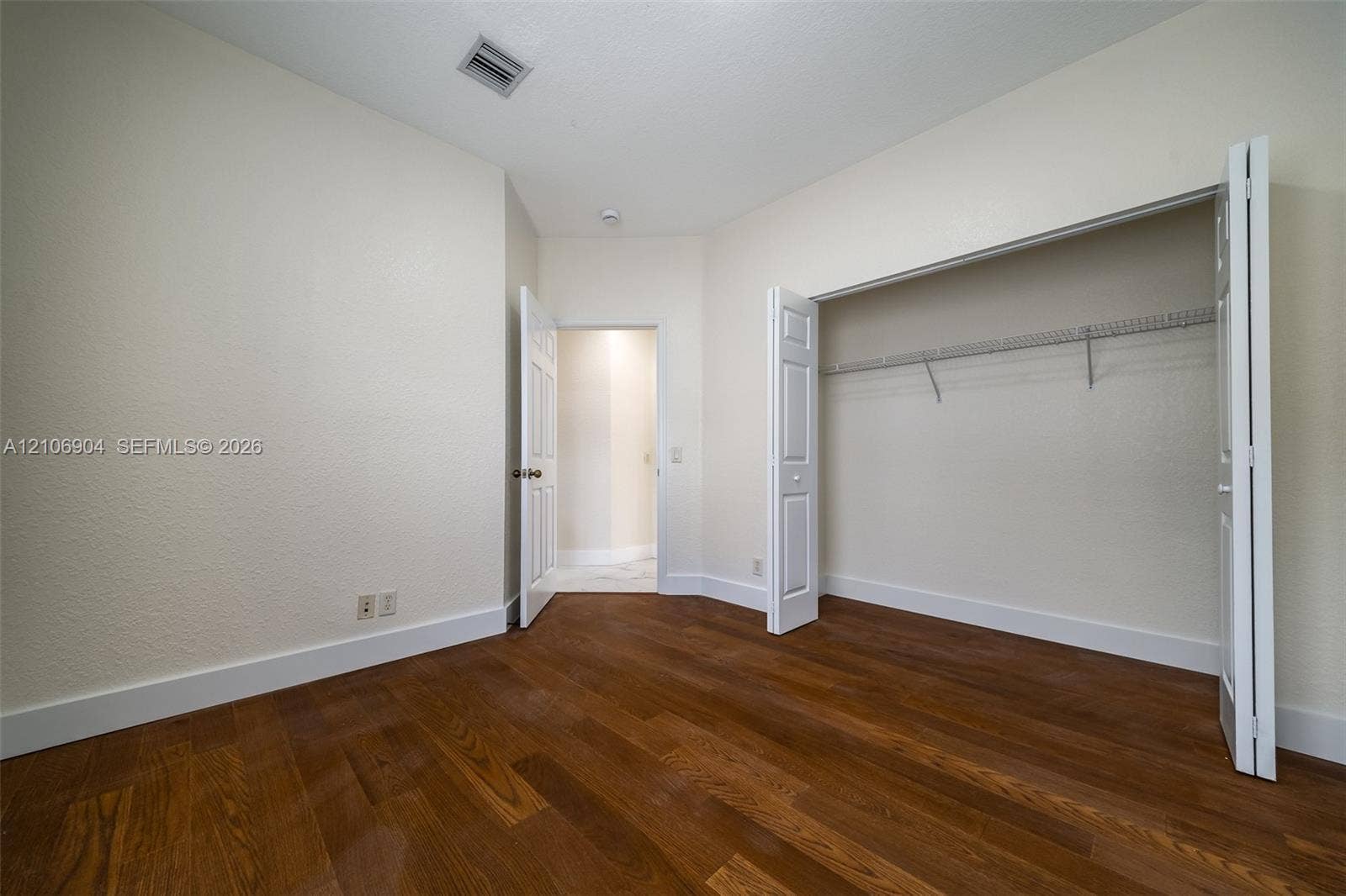 297 Conservation Drive, Weston, FL 33327 Wood-finish flooring, neutral wall tones, bi-fold closet doors, and interior paneled doors
