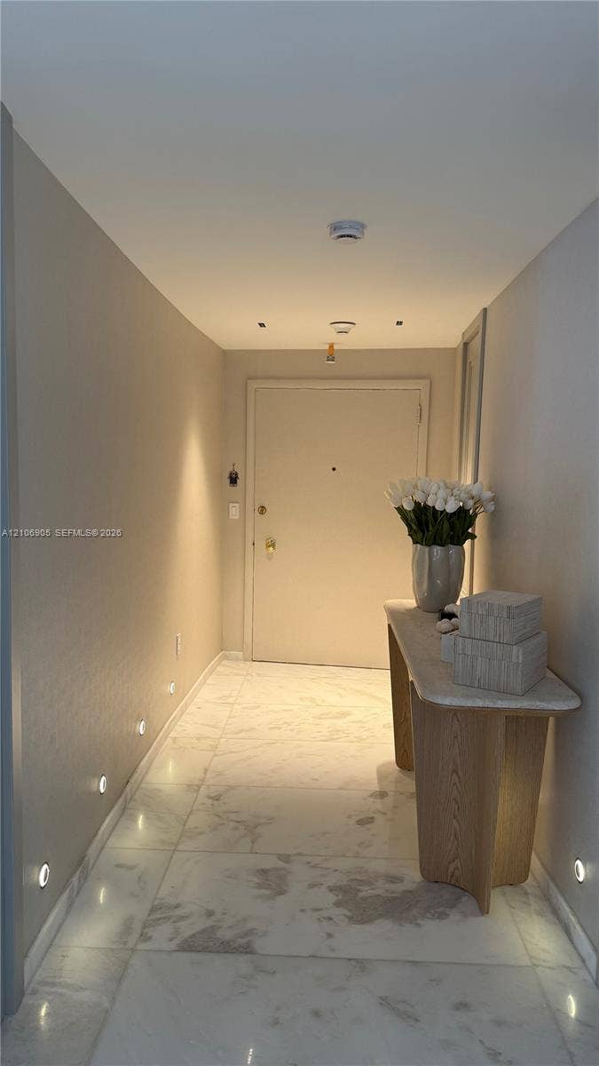 720 NE 69th Street, #10N, Miami, FL 33138 Entrance featuring large-format light-toned stone-finish flooring and integrated low-profile wall lighting