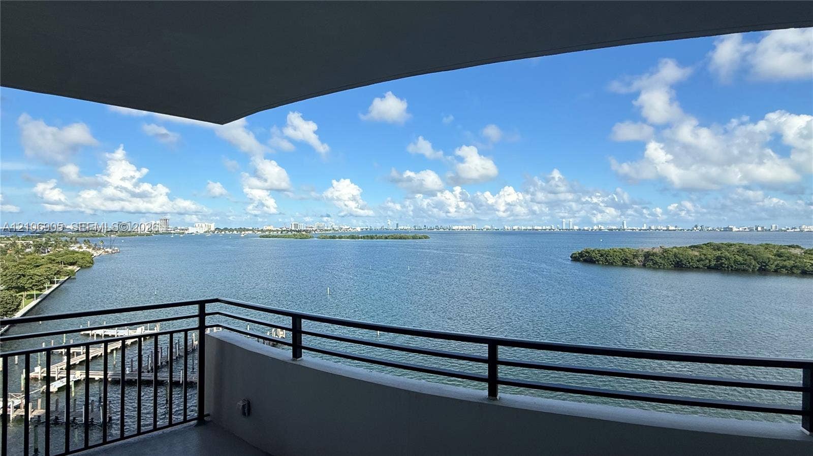 720 NE 69th Street, #10N, Miami, FL 33138 Covered balcony featuring black metal railings and direct water frontage