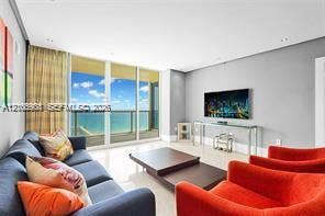 Floor-to-ceiling glass panel windows, polished tile flooring, and integrated recessed lighting
