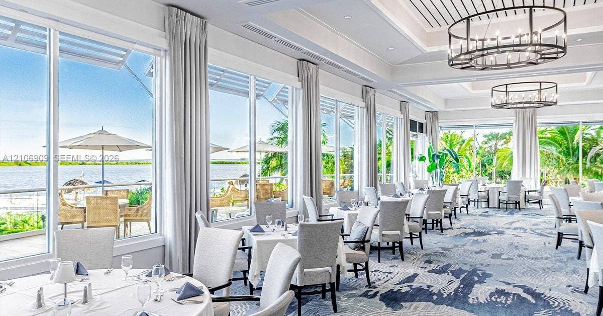 331 Wild Orchid Lane, Marco Island, Marco Island, FL 34145 Floor-to-ceiling windows featuring panoramic water scenery, coffered ceilings, and custom oval pendant lighting