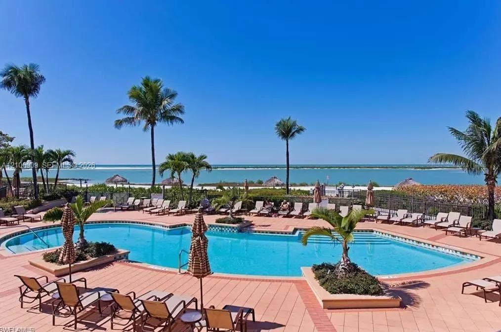 331 Wild Orchid Lane, Marco Island, Marco Island, FL 34145 Swimming pool with tiled decking, built-in planters, and perimeter fencing