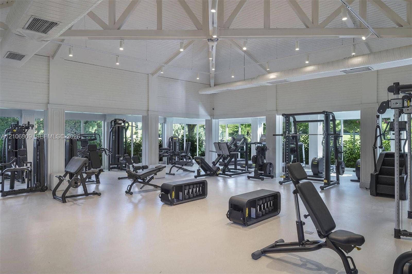 331 Wild Orchid Lane, Marco Island, Marco Island, FL 34145 Vaulted ceilings with exposed structural trusses, shiplap wall paneling, integrated recessed lighting, and expansive floor-to-ceiling windows