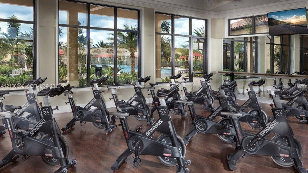 331 Wild Orchid Lane, Marco Island, Marco Island, FL 34145 Fitness center featuring wood-finish flooring, floor-to-ceiling windows, and wall-to-wall mirrors