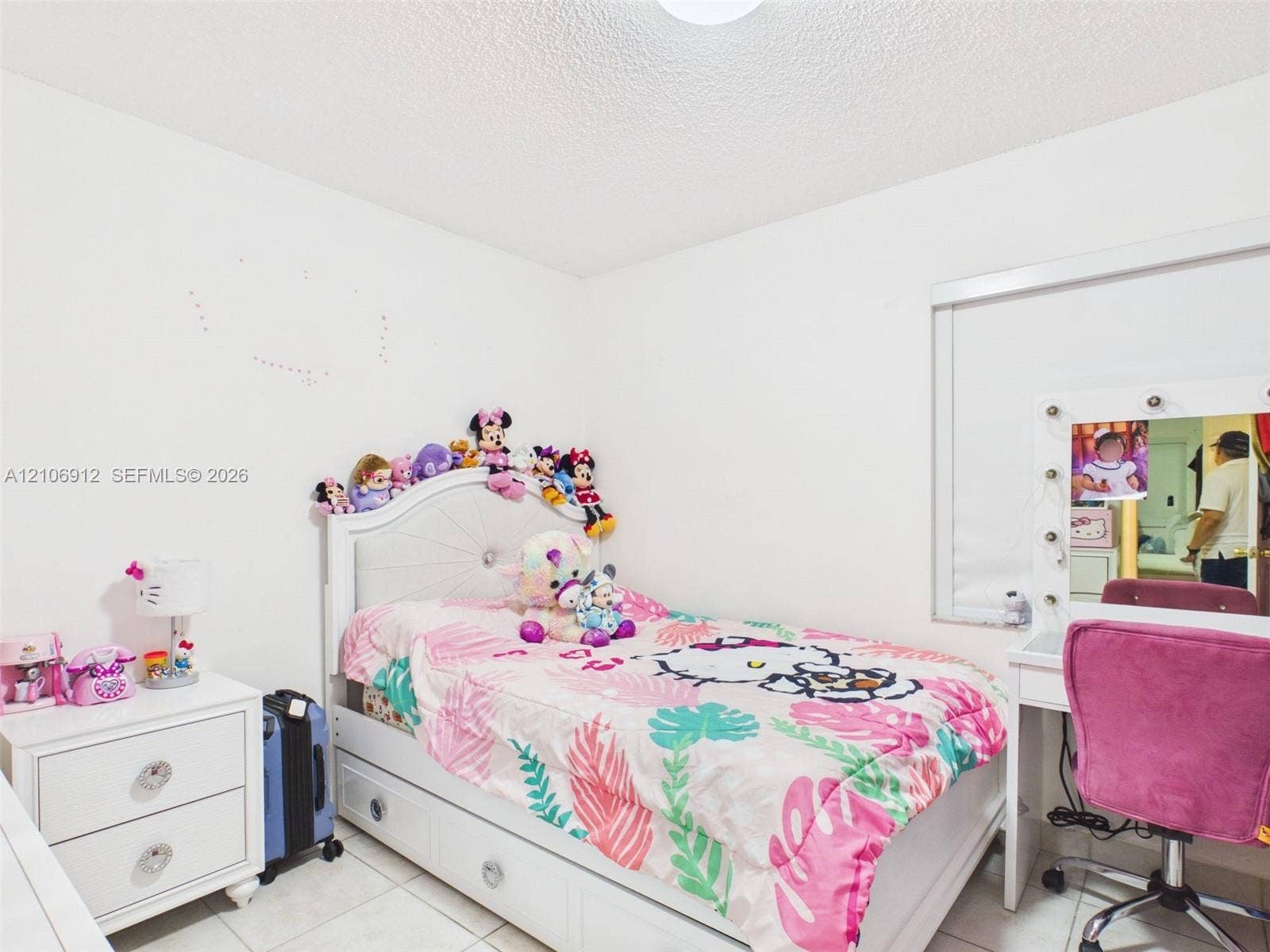 1142 W 42nd Street, #19, Hialeah, FL 33012 Room featuring white walls, large-format tile flooring, and a window equipped with an integrated roller shade
