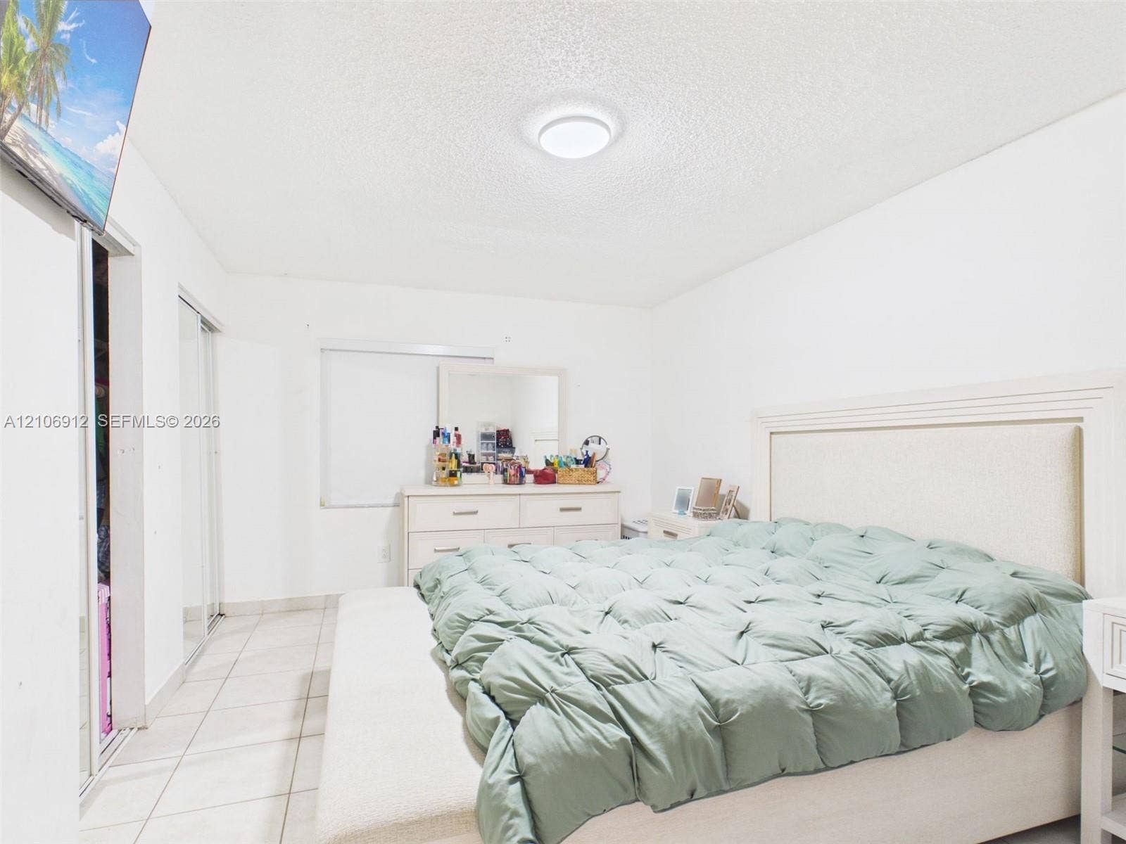 1142 W 42nd Street, #19, Hialeah, FL 33012 Neutral-toned tile flooring, flush-mount ceiling lighting, and floor-to-ceiling mirrored closet doors