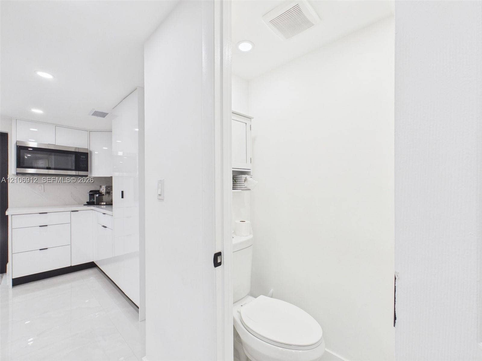 1142 W 42nd Street, #19, Hialeah, FL 33012 High-gloss cabinetry, stainless steel built-in microwave, stone countertops, recessed lighting, and tile flooring