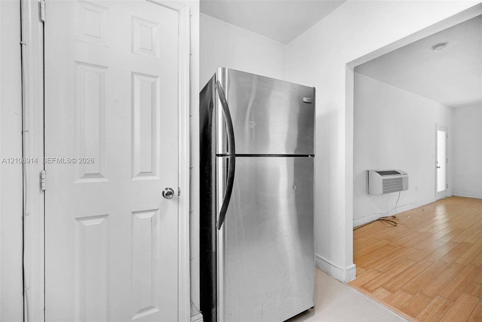 320 85th Street, #20, Miami Beach, Miami Beach, FL 33141 Stainless steel refrigerator, wood-finish flooring, and six-panel interior door