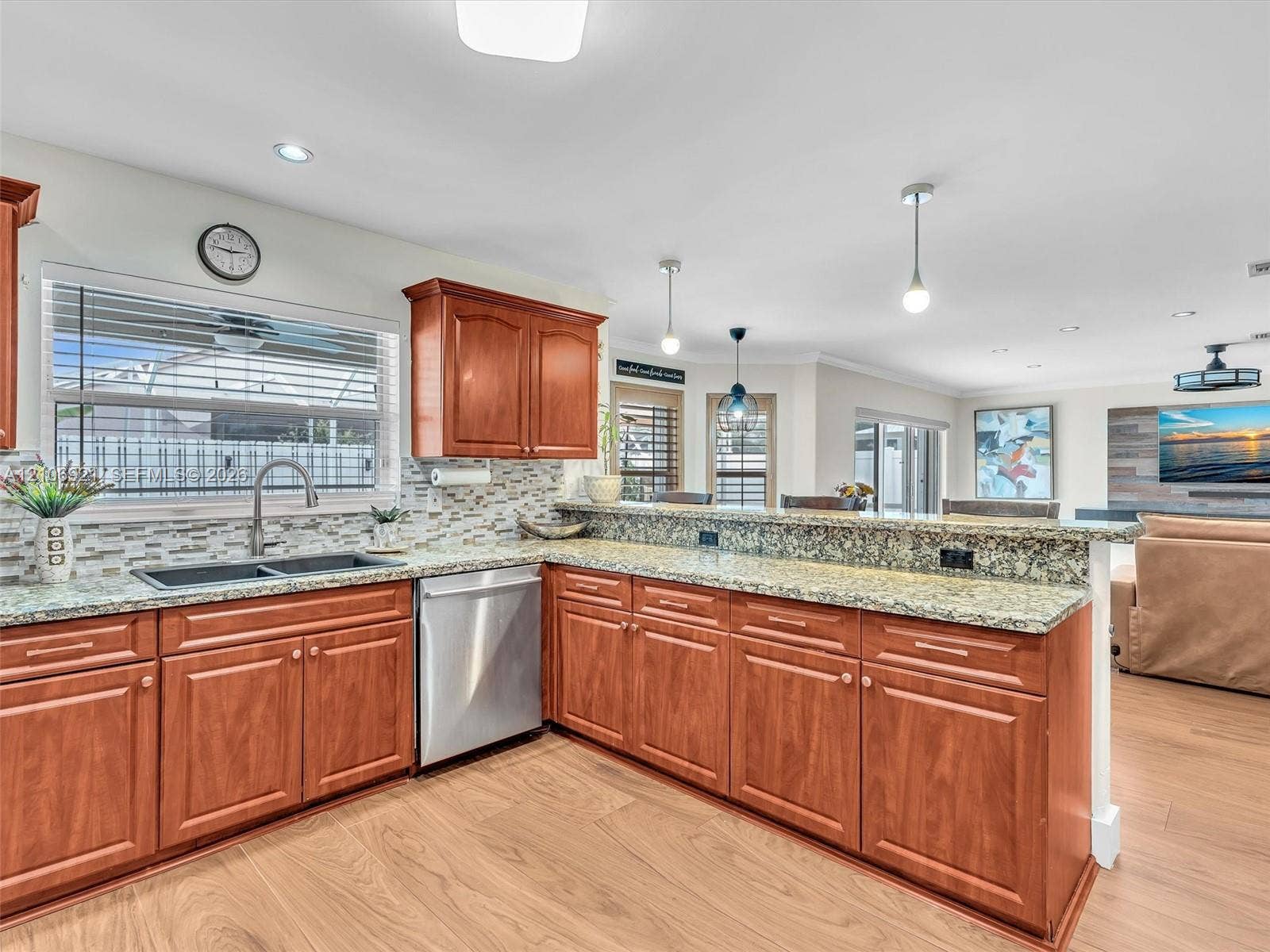 Kitchen featuring wood cabinetry, stone-surface countertops, mosaic tile backsplash, recessed lighting, and stainless steel dishwasher