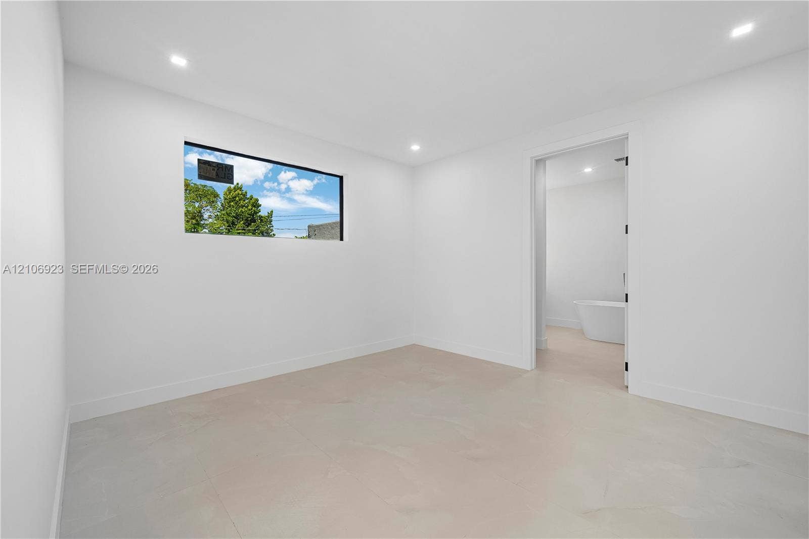 870 Superior Street, Opa Locka, FL 33054 Interior room featuring recessed ceiling lighting, large-format tile flooring, and a horizontal window with a black frame