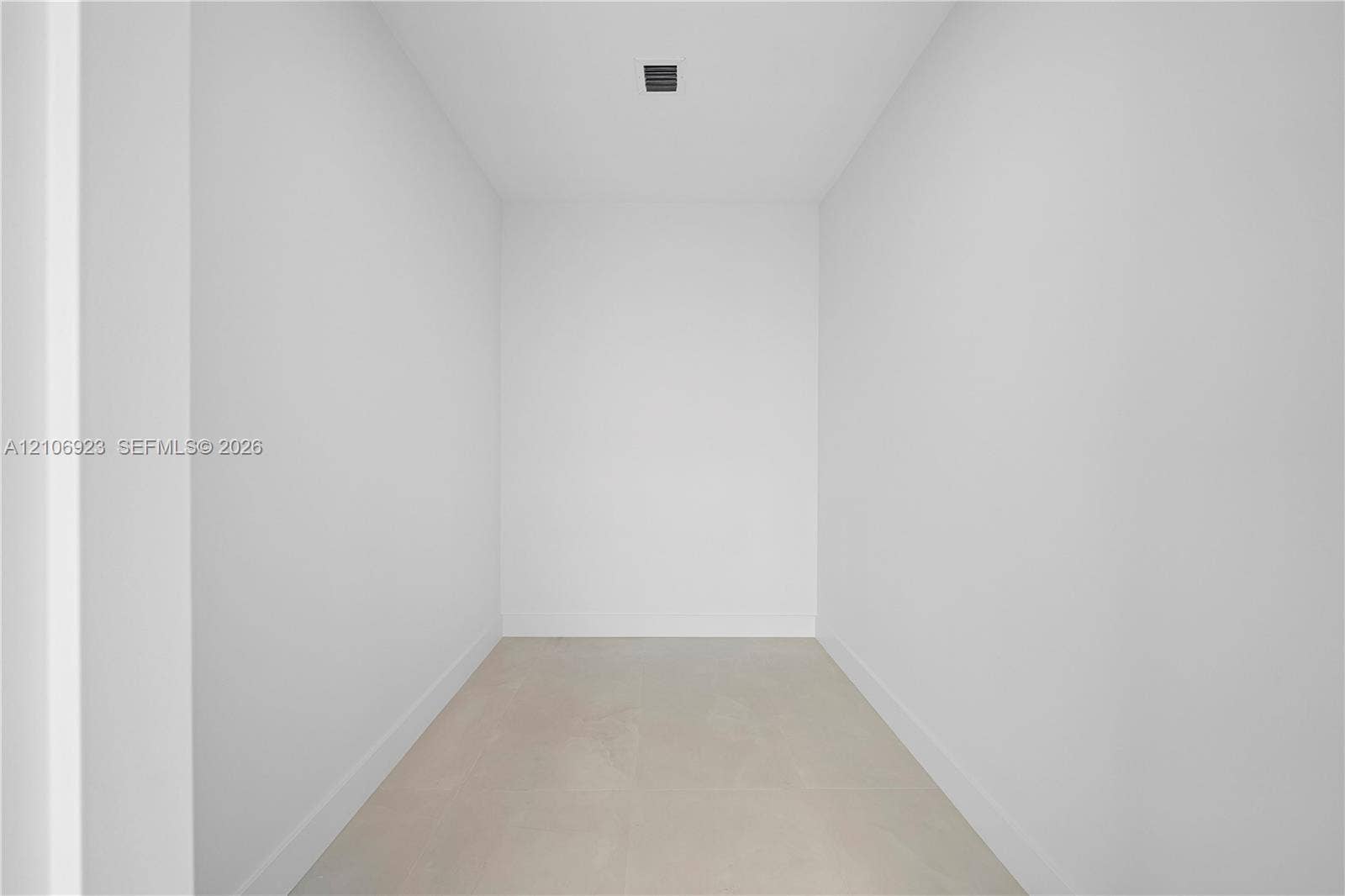 870 Superior Street, Opa Locka, FL 33054 Minimalist interior space featuring neutral wall tones, large-format tile flooring, and recessed ceiling lighting