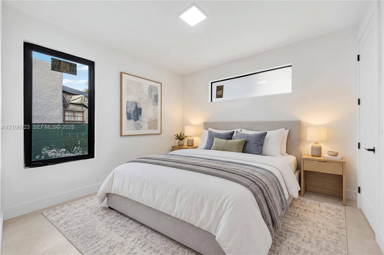 870 Superior Street, Opa Locka, FL 33054 Neutral interior space featuring high-contrast black-framed windows, a horizontal transom window, recessed ceiling lighting, and hard-surface flooring