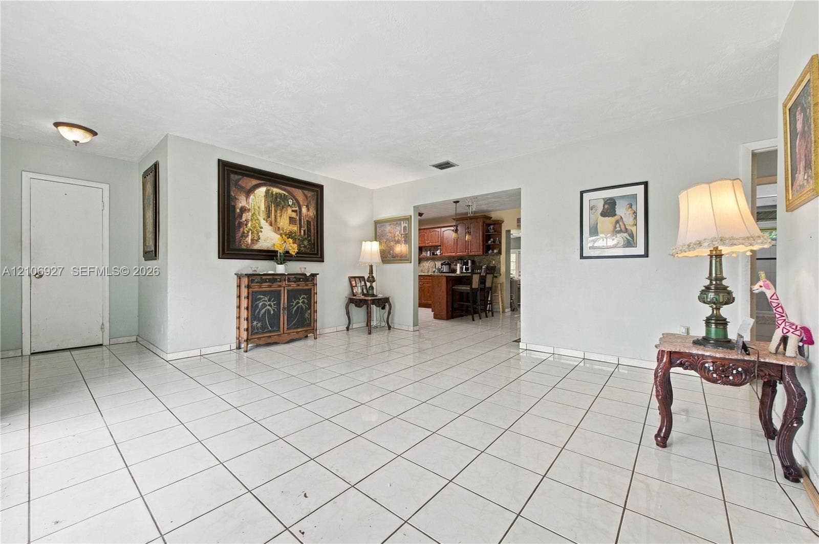 Living area featuring large-format ceramic tile flooring, neutral wall tones, and recessed lighting