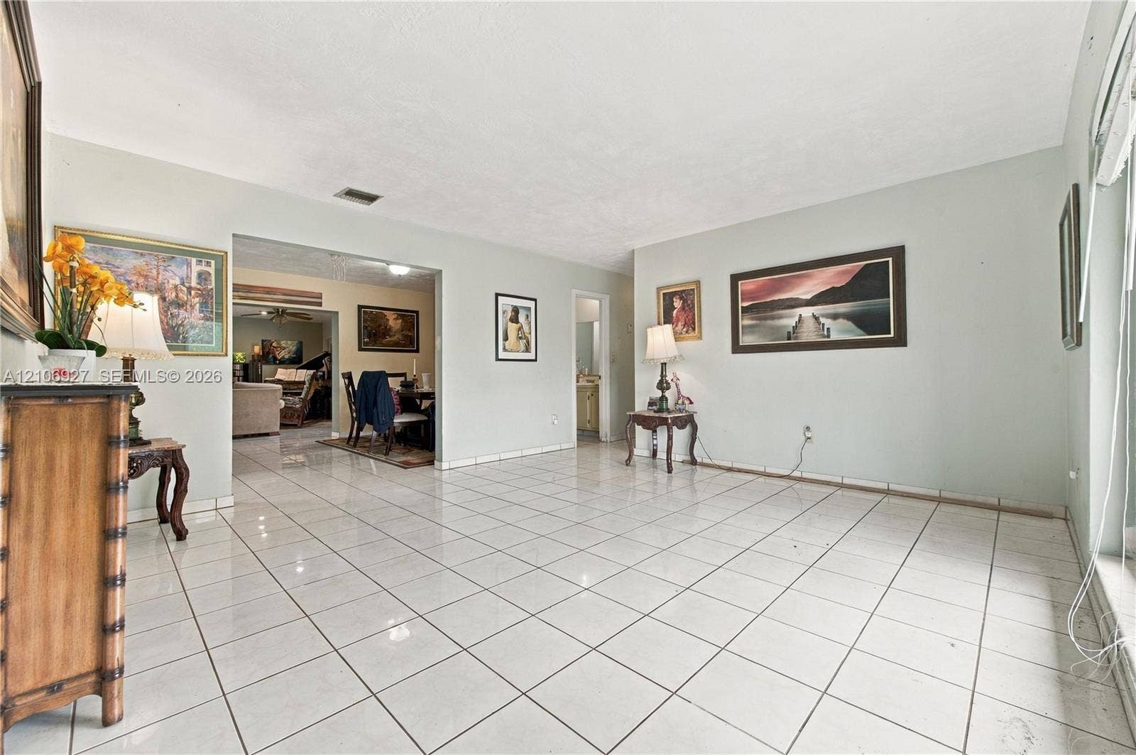 Neutral-toned interior space featuring light-colored ceramic tile flooring and smooth, finished wall surfaces