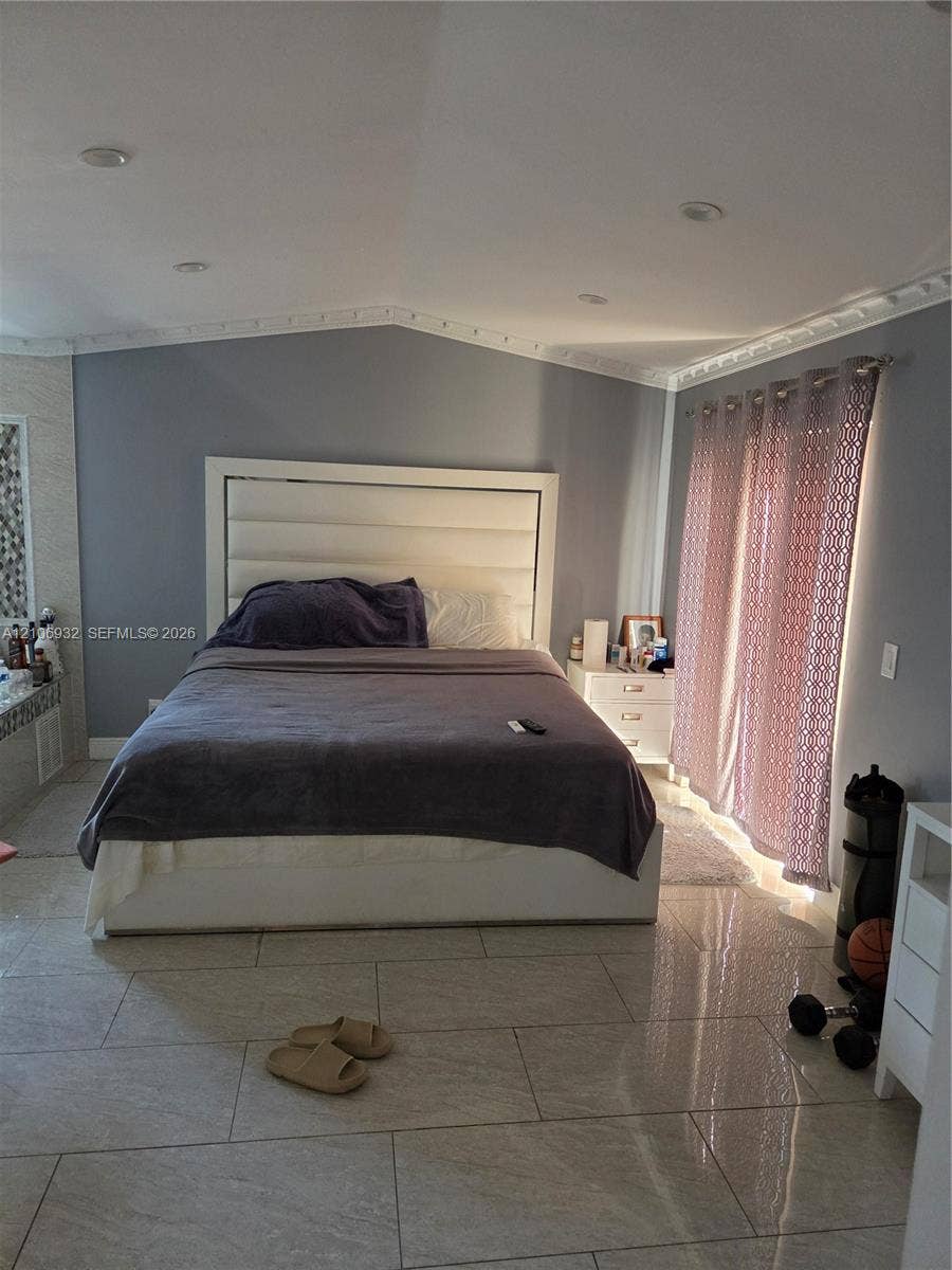 6328 NW 181st Terrace, Hialeah, FL 33015 Vaulted ceilings with crown molding, large-format tile flooring, and recessed lighting