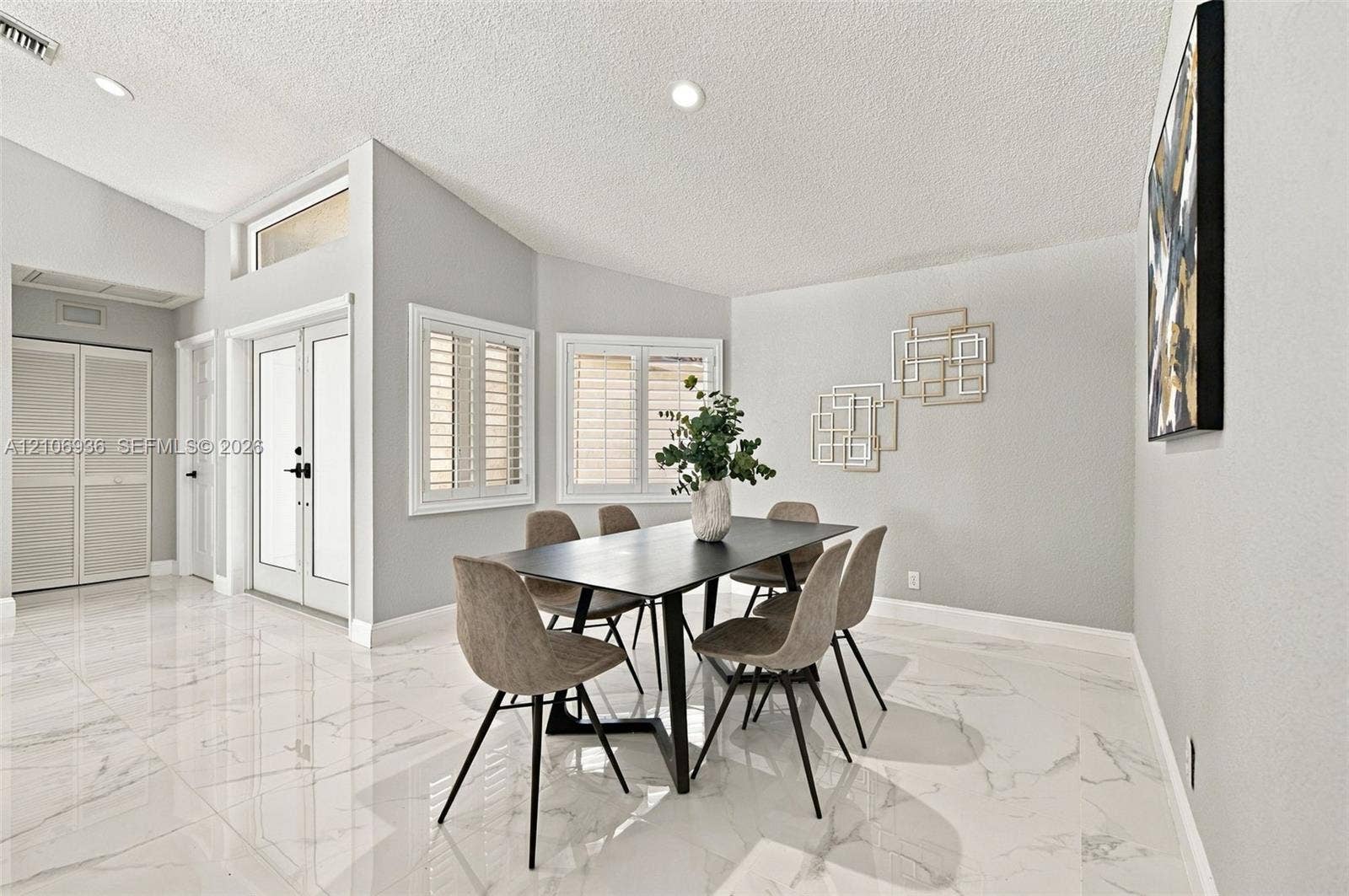 High-gloss tile flooring, vaulted ceilings, double entry doors with glass inserts, transom windows, and window shutters