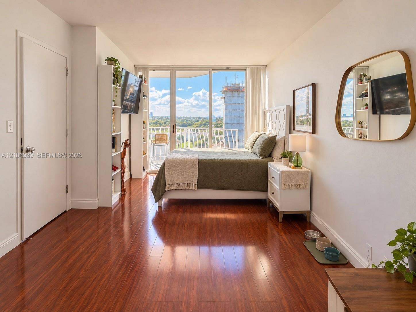 7601 E Treasure Drive, #802, North Bay Village, North Bay Village, FL 33141 Wood-finish flooring, floor-to-ceiling windows, and access to a private balcony