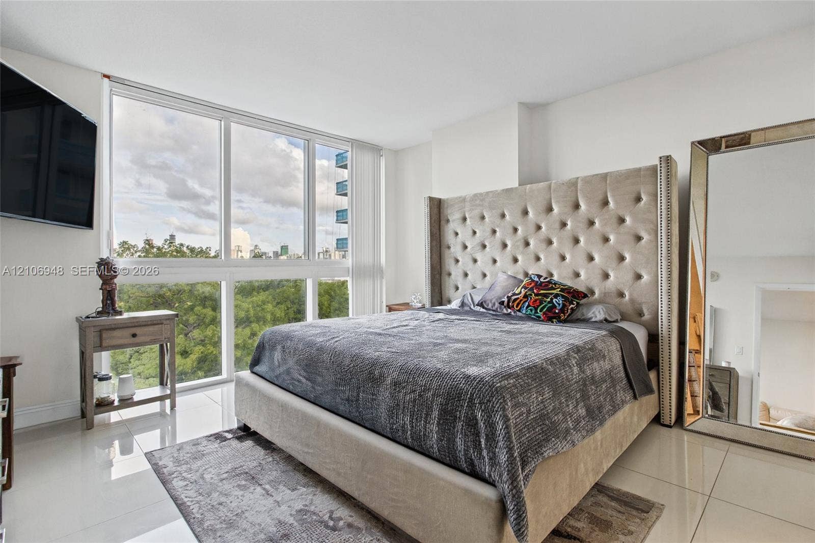 Floor-to-ceiling windows featuring expansive exterior scenery and polished tile flooring