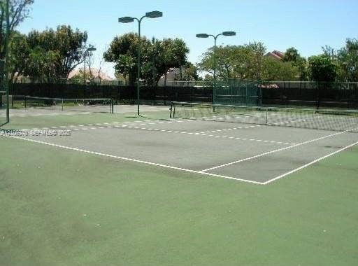 504 Gardens Drive, #101, Pompano Beach, Pompano Beach, FL 33069 Hard-surface tennis courts featuring perimeter fencing, integrated net systems, and overhead lighting