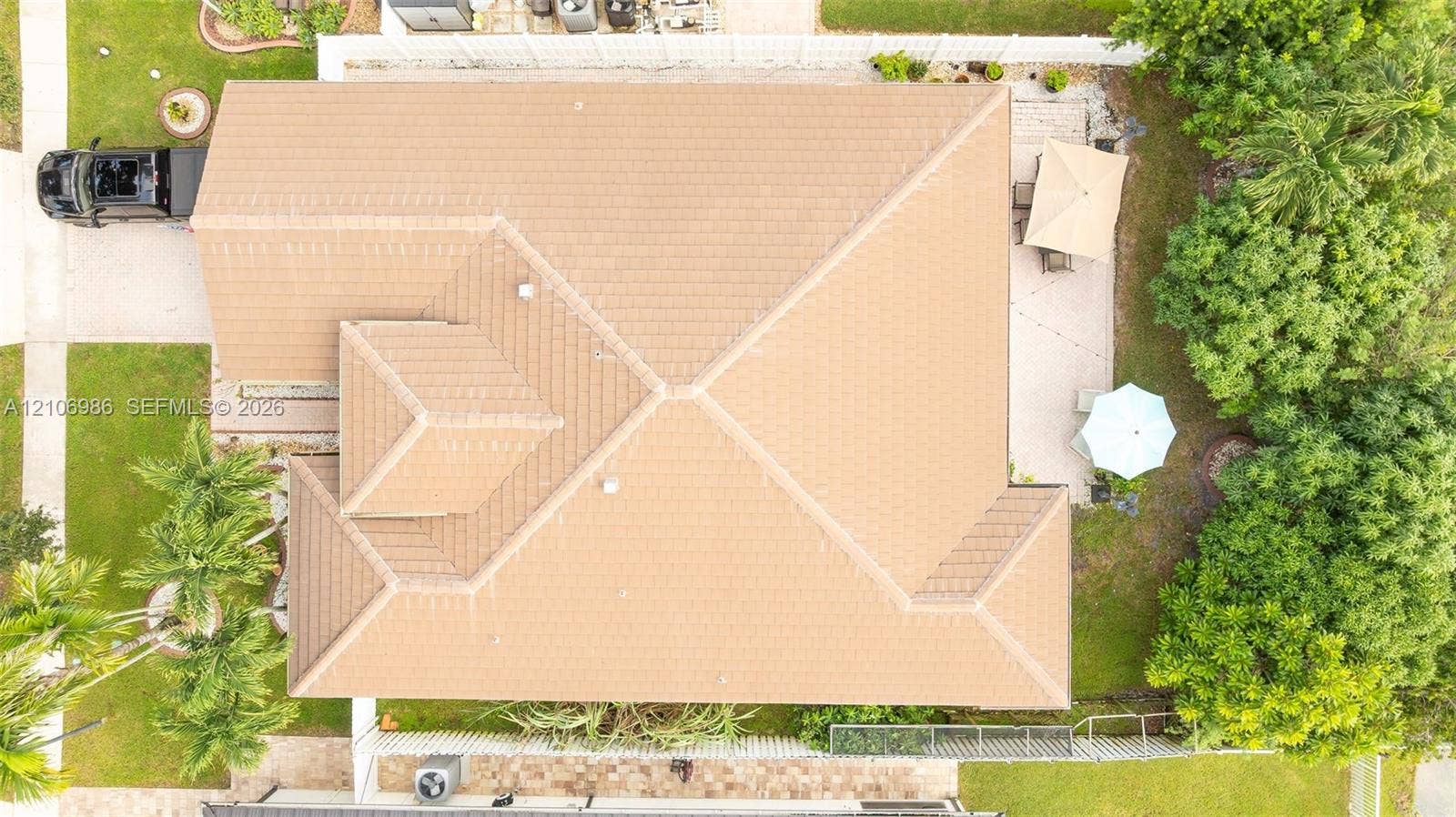 3801 SW 147th Avenue, Miramar, FL 33027 Aerial perspective of a property featuring a multi-pitch tile roof, a paved rear patio, and established perimeter landscaping