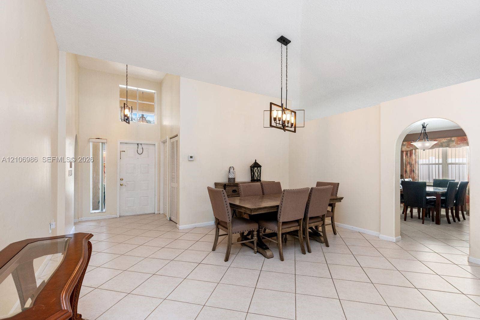 3801 SW 147th Avenue, Miramar, FL 33027 Vaulted ceilings, large-format tile flooring, a geometric metal chandelier, and a prominent arched entryway