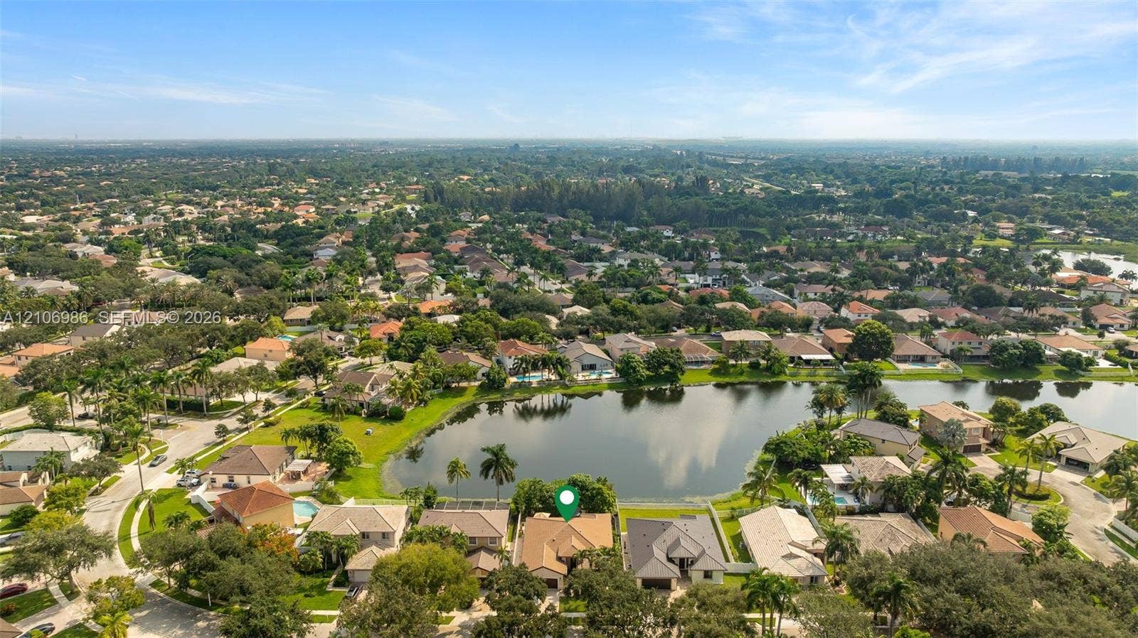3801 SW 147th Avenue, Miramar, FL 33027 Aerial perspective featuring a waterfront property with a concrete tile roof and a screened-in lanai