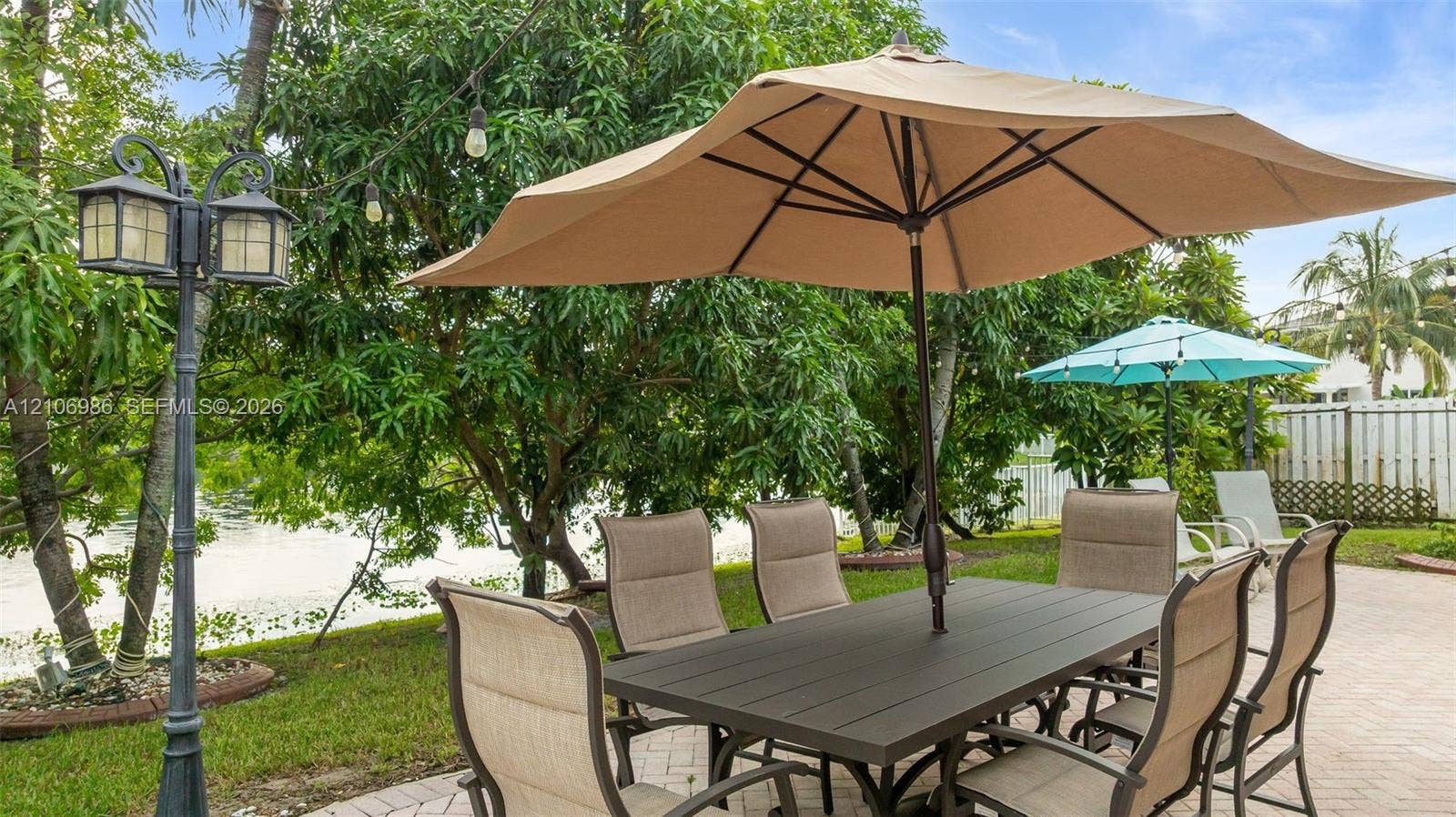 3801 SW 147th Avenue, Miramar, FL 33027 Paver patio featuring a decorative metal lamp post and mature perimeter landscaping