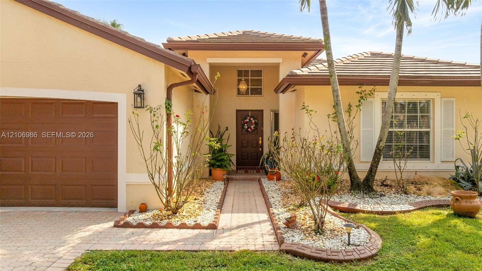 3801 SW 147th Avenue, Miramar, FL 33027 Stucco exterior with a tiled roof, paver driveway, walkway, recessed entryway, and attached garage